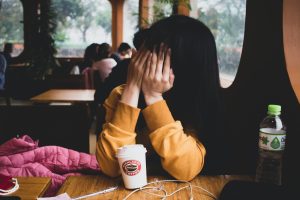 woman-covering-her-face-2029239