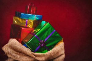 Sack of Sinterklaas with gifts .Burlap bag on red background. Vintage editing.